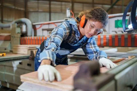 Factory Worker Operating Machinery to Process Wooden Panels Stock Photos