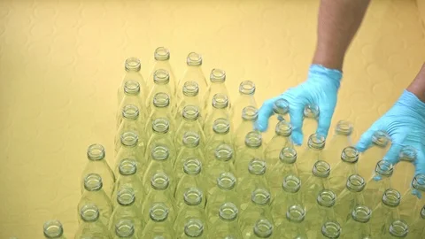 Factory worker picking bottle to filling machine. Stock Footage 92435763