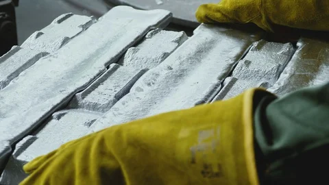 Factory worker picks up aluminum ingot Stock Footage