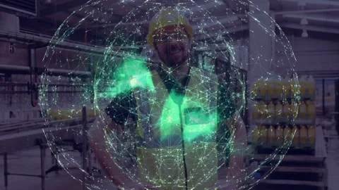 Factory worker posing as green hologram appearing, fading in plant, wearing Stock Footage 331635438