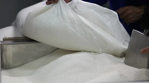 Factory worker pouring sugar sand from bag into container for sugar refinery pro Stock Footage 36728780