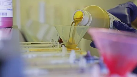 A factory worker pours dye into a textile printing machine Stock-Footage 69855159