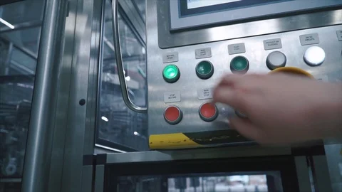 Factory worker presses the button on the control point and starts conveyor of Stock Footage 88019885