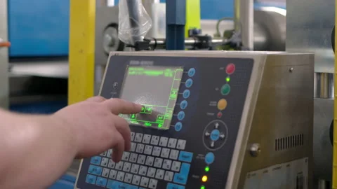 Factory worker is programming, checking by pressing buttons of automated Video stock 161655609