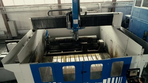 Factory worker is programming a CNC milling machine with a tablet computer. Video stock 106451926
