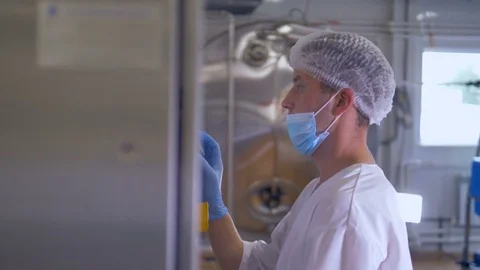 A factory worker programs the industrial computer. Stock Footage 79216233