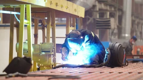 Factory worker in protective uniform and safety mask during the welding work Stock Footage 202049066