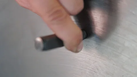Factory worker puts the mark on the product with a hammer. Equipment production Stock Footage 127555479