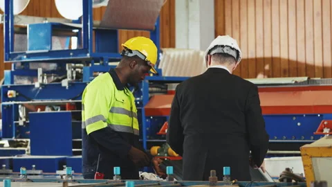 Factory worker in safety suit, Project manager discussing with engineering .. Stock Footage 242714506