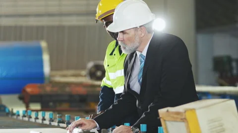 Factory worker in safety suit, Project manager discussing with engineering .. Stock Footage 242714608