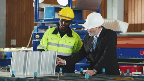 Factory worker in safety suit, Project manager discussing with engineering .. Stock Footage 242714671
