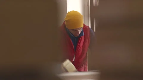 Factory worker sealing packages with tape Stock Footage 233071625