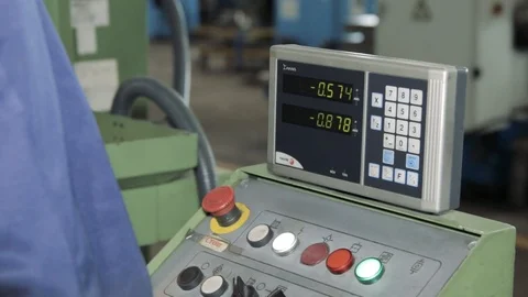 Factory Worker is Setting Up CNC Lathe Machine in Factory Stock Footage 111247434