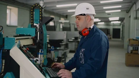 A factory worker is standing at the control panel. Stock Footage 126163264