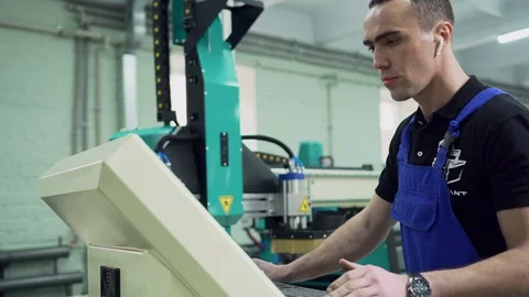 A factory worker is standing at the control panel. Stock Footage 127054149