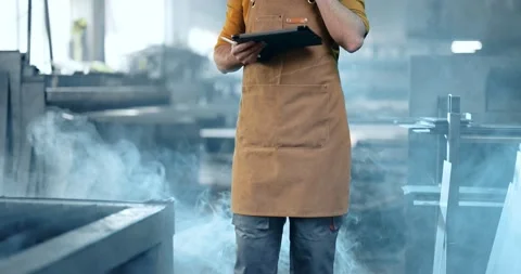 Factory worker with tablet and phone at the manufacturing Stock Footage 147289733