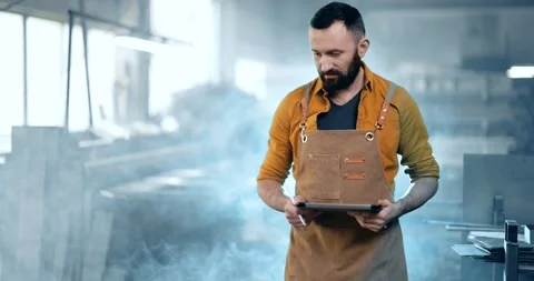 Factory worker with tablet and phone at the manufacturing Stock Footage 147290165