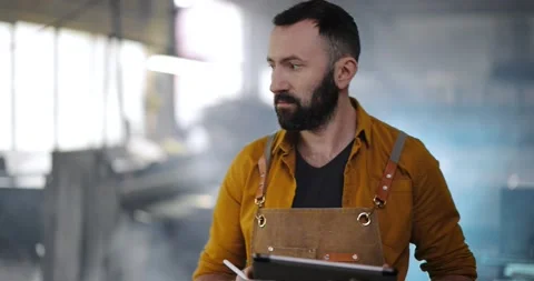 Factory worker with tablet and phone at the manufacturing Stock Footage 147291024