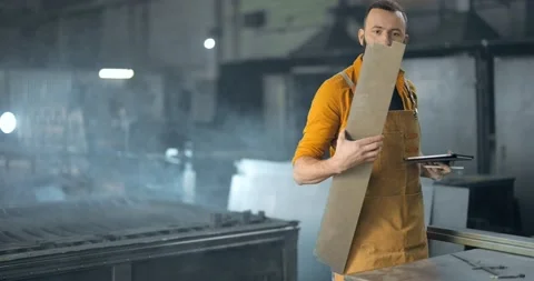 Factory worker with tablet and phone at the manufacturing Stock Footage 147291484