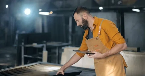 Factory worker with tablet and phone at the manufacturing Stock Footage 147292304