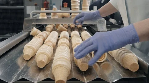 Factory worker takes waffle cups from production line Stock Footage 124892509