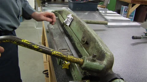 Factory worker uses machine to create metal piece Stock Footage 42959544