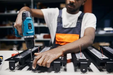 Factory worker using electric screwdriver Stock Photos