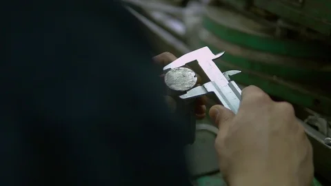 A factory worker is using a slide gauge to measure some detail. Stock Footage 118188612