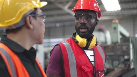Factory worker walking and explaining work to colleague Stock Footage 194415492