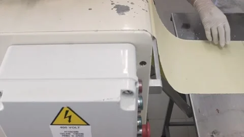 Factory worker wearing gloves preparing to cut into pieces a large piece of d Video stock 132972793