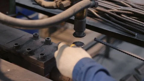 Factory worker welds rebar elements with special machine Stock Footage 124299162