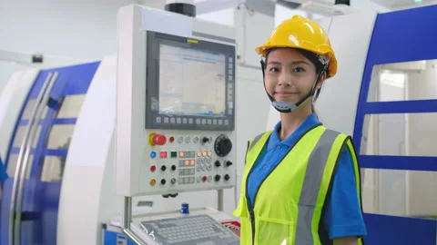 Factory worker woman control machine working in workplace area Stock Footage 147459336