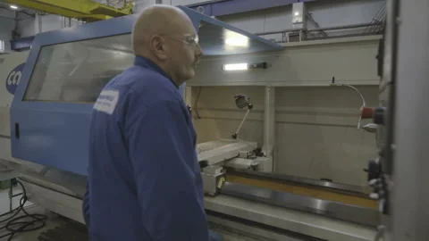 Factory worker working on a CNC metal milling machine Stock-Footage 103354722