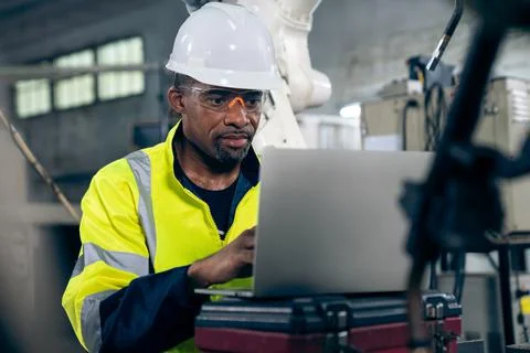 Factory worker working with laptop computer to do adept procedure checklist Stock Photos