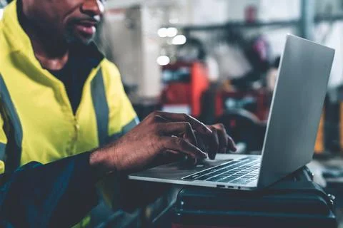 Factory worker working with laptop computer to do adept procedure checklist Stock Photos
