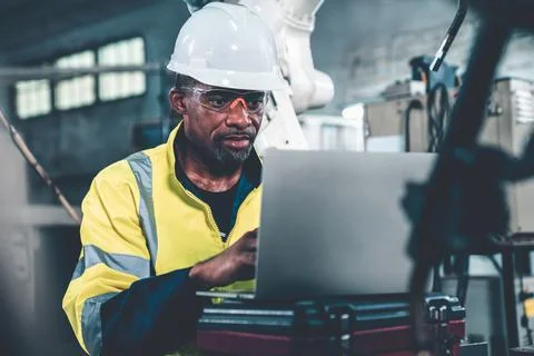 Factory worker working with laptop computer to do adept procedure checklist Stock Photos