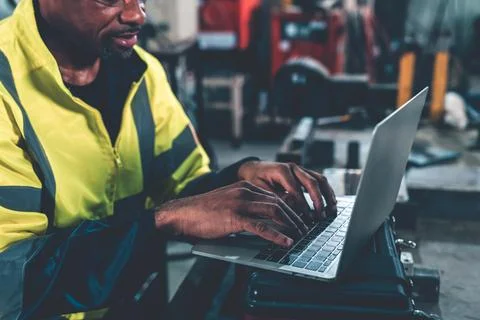 Factory worker working with laptop computer to do adept procedure checklist Stock Photos