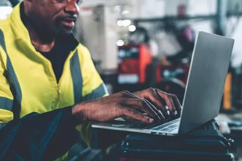 Factory worker working with laptop computer to do adept procedure checklist Stock Photos