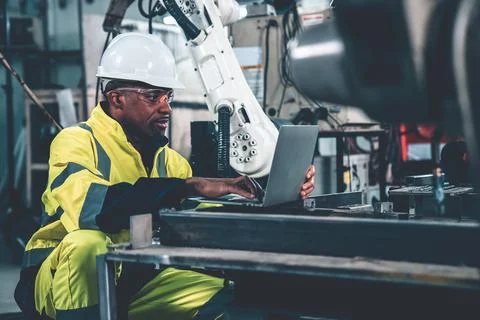 Factory worker working with laptop computer to do adept procedure checklist Stock Photos