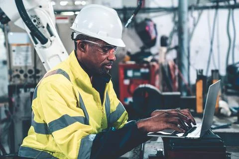 Factory worker working with laptop computer to do adept procedure checklist Stock Photos
