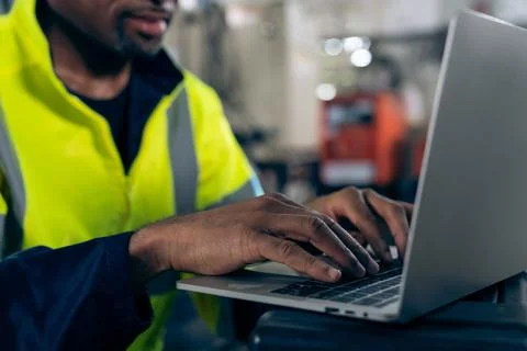 Factory worker working with laptop computer to do adept procedure checklist Stock Photos