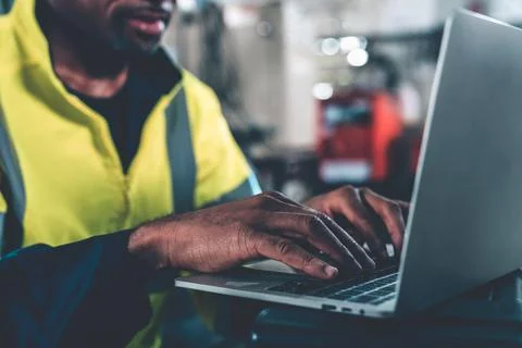 Factory worker working with laptop computer to do adept procedure checklist Stock Photos