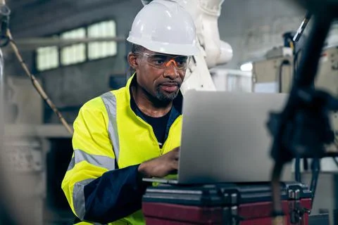 Factory worker working with laptop computer to do adept procedure checklist Stock Photos