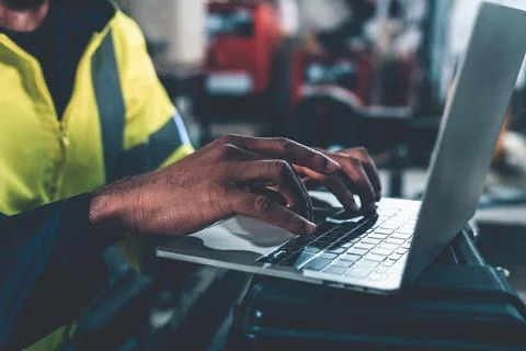 Factory worker working with laptop computer to do adept procedure checklist Stock Photos