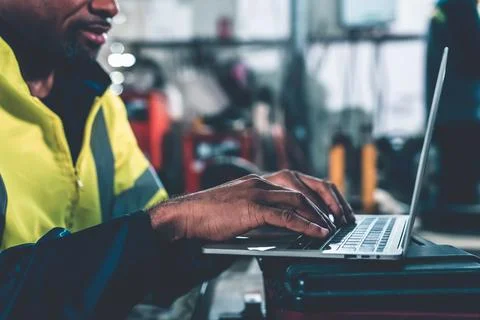 Factory worker working with laptop computer to do adept procedure checklist Stock Photos