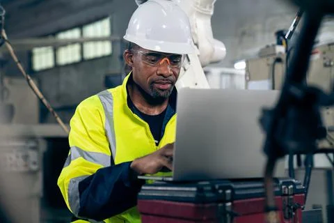 Factory worker working with laptop computer to do adept procedure checklist Stock Photos