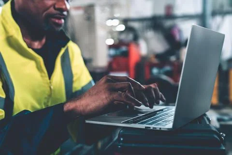 Factory worker working with laptop computer to do adept procedure checklist Stock Photos