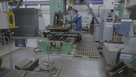 Factory worker working on a metal milling machine Stock Footage 103354803