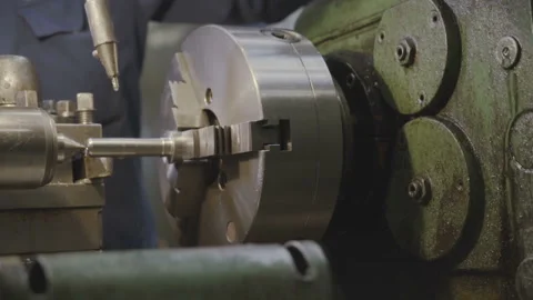 Factory worker working on a metal milling machine. Cutting metal, old technology Stock Footage 103355429