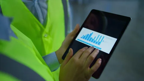 Factory workers analizing graphs checking data on tablet screen hands closeup Stock Footage 169886715